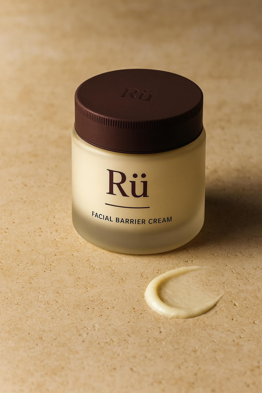 The Rü jar on a travertine ledge, lid on, the printed Rü label facing the camera, one swipe of the cream drawn across the stone beside it